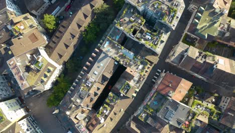 Birds-Eye-Aerial-View-Flying-Above-Predigerkirche-Church-in-Zurich's-Famous-Old-Town