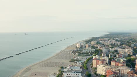 Aerial-shot-of-sandy-beach-with-umbrellas-and-gazebos