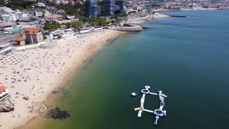 AERIAL-Orbiting-Shot-of-the-Biggest-Beach-in-Cascais,-Portugal