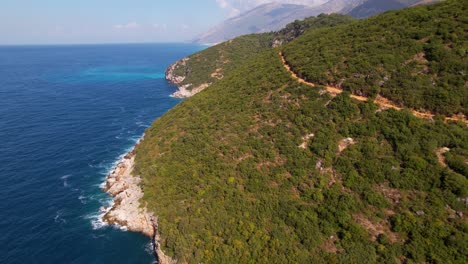 Summer-colors-of-Mediterranean-coastline-with-green-vegetation-and-blue-sea-water-splashing-on-rocks