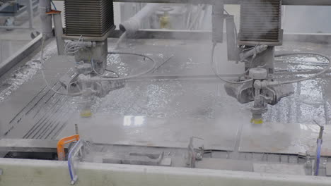 Dual-Water-jet-cutting-machines-cutting-steel-with-steam-rising