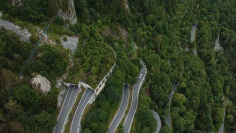 Fliegen-über-Die-Ikonische-Gebirgsschlangenstraße-Plöckenpass-In-Italien-Durch-Die-Natürlichen-österreichischen-Alpen-Im-Sommer-Mit-Grünen-Waldbäumen,-Tunneln-Und-Autos-Auf-Der-Straße