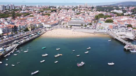 AERIAL-Ascending-Shot-of-Cascais-Bay,-Portugal-with-Seagulls-flying-below