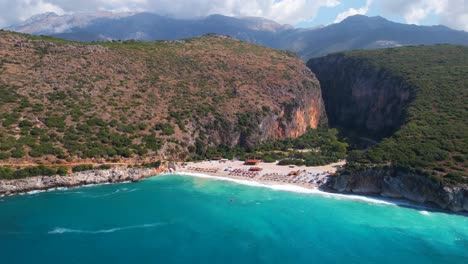 Bay-of-Gjipe-in-Albania,-beautiful-unspoiled-beach-through-rocky-hills-washed-by-turquoise-sea-water