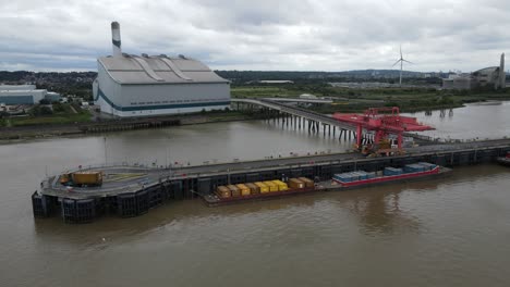 Barges-Loading-Waste-at-Cory-Riverside-plant-on-River-Thames-Kent-UK-Aerial-footage
