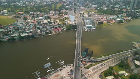 Traffic-and-cityscape-of-Victoria-Island,-Lagos,-Nigeria-featuring-Falomo-Bridge,-Lagos-Law-school-and-the-Civic-centre-tower