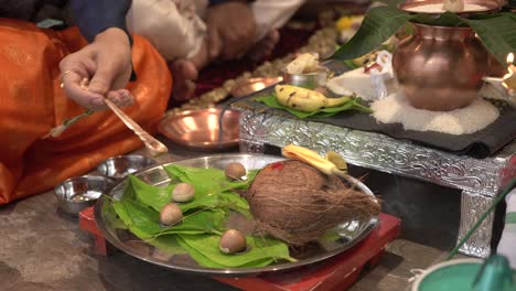 husband-and-wife-both-are-seeting-gruhpravesh-pooja-and-droped-water-on-supari