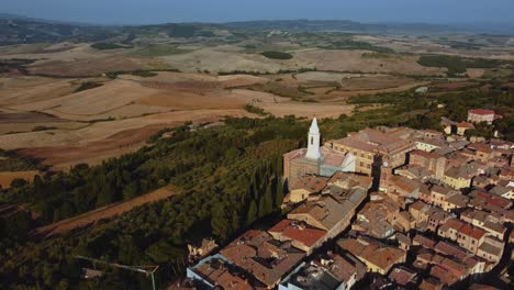 Flight-over-Pienza,-a-beautiful-old-village-in-the-heart-of-Val-d'-Orcia-near-Siena-in-Tuscany,-Italy,-a-masterpiece-of-mediterranean-historic-architecture-in-the-idyllic-landscape