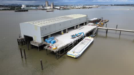 Barge-Unloading-at-Dock-on-River-Thames-UK-Essex-drone-footage