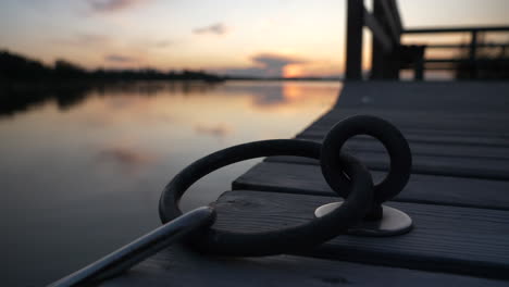 Detail-shot-of-Mooring-ring-at-harbour-in-Archipelago-of-Turku,-Finland,-at-sunset