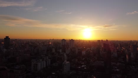 AERIAL---Beautiful-sunset-over-apartment-buildings-in-Buenos-Aires,-Argentina