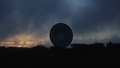 Zeitraffer-Von-Wolken,-Die-Sich-über-Eine-Radioteleskopschüssel-Bewegen,-Dunkler,-Düsterer-Abend