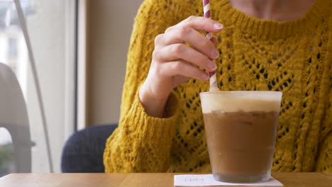 Slow-motion-camera-shot-of-woman-sitting-in-the-coffee-bar