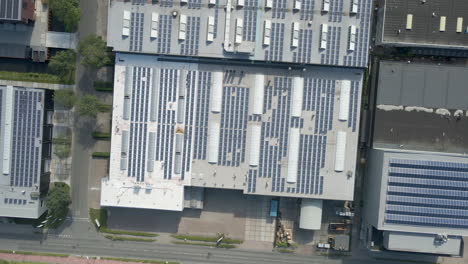 Top-down-aerial-of-solar-panels-on-office-building-rooftop