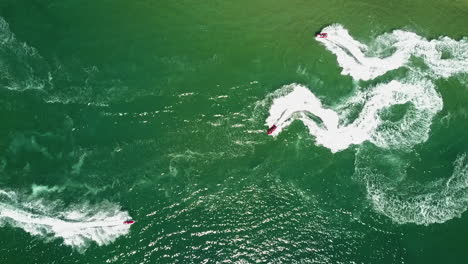 bird's-eye-view-of-jet-skis-almost-crashing-in-yellow-and-green-water