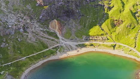 Snowdonia-national-park---slow-descending-aerial-over-the-emerald-waters-of-lake-Llyn-Llydaw