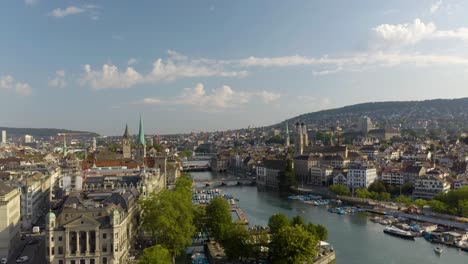 Aerial-Ascending-Shot-Reveals-Zurich-Cityscape-where-Lake-Zurich-meets-the-Limmat-River