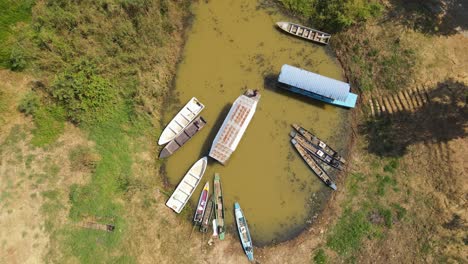 An-overhead-aerial-footage-of-a-Boat-Tour-in-Bueng-Boraphet,-Nakhon-Sawan,-Thailand,-going-out-to-explore-the-swamp-and-lake-for-migratory-birds-from-different-countries-around-the-world