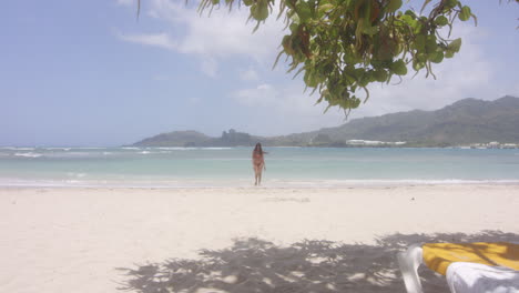Carefree-Latin-Girl-Walks-to-Beach-Lounger-from-Swim-in-Turquoise-Blue-Ocean-of-Playa-Teco-Maimon