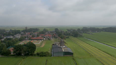Aerial-of-beautiful-old-classic-wind-mill-in-a-scenic-rural-town