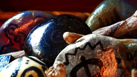 Magical-painted-Viking-drawing-patterned-spiritual-stones-colourful-hobby-art-collection-in-wooden-box-with-burning-incense