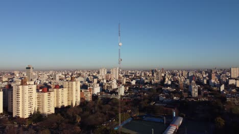 AERIAL---Large-antenna-radio-tower-in-Buenos-Aires,-Argentina,-wide-circle-shot