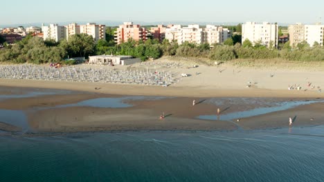 Aerial-shot-of-sandy-beach-with-umbrellas-and-gazebos