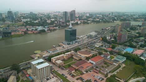 Traffic-and-cityscape-of-Falomo-Bridge,-Lagos-Law-school-and-the-Civic-centre-tower-in-Lagos-Nigeria