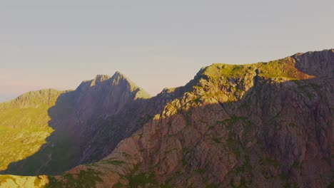 Sunrise-aerial-dolly-in-over-the-ridgelines-of-Mount-Snowden-in-Snowdonia-National-Park-in-Wales