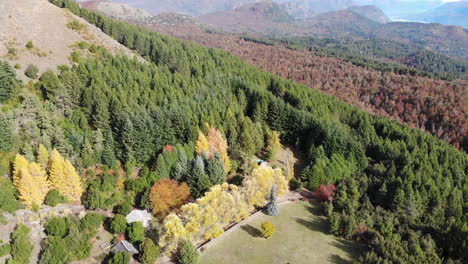 Aerial-backwards-shot-showing-multicolored-landscape-of-Patagonia-with-cozy-house-in-summer---Bariloche,Argentina