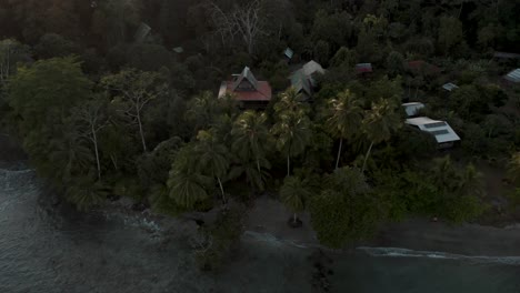 Drone-flight-reveals-stunning-coastal-location-of-Punta-Mona,-surrounded-by-dense-jungle