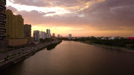 Water-canal-cityscape-orange,-yellow-and-pink-sunset,-Mexico