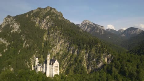 Picturesque-Drone-Pullback-Reveals-Fantasy-Castle-Landscape-Built-into-Alp-Mountains