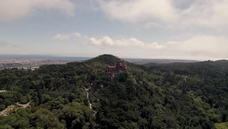 Panoramic-panning-shot-on-Sintra-Hills-overlooking-at-historic-monument-Pena-palace-and-cloudscape