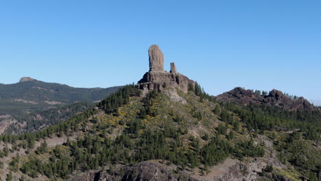 Aerial-drone-footage-of-beautiful-stunning-landscape-view-off-the-Roque-Nublo-rock-formation-and-plateau-at-Gran-Canaria-Spain-with-a-valleys-and-many-small-peaks-on-a-sunny-day