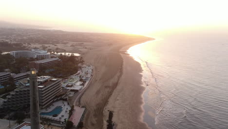 Aerial-sunset-shot-of-Lighthouse-of-Maspalomas-in-Gran-Canaria,-Canary-Islands,-Spain