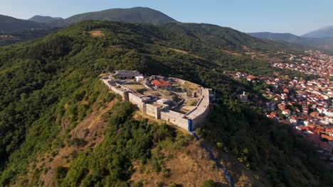 Prizren-castle-built-on-the-top-of-the-hill-above-the-city-in-Kosovo,-aerial-panoramic-drone