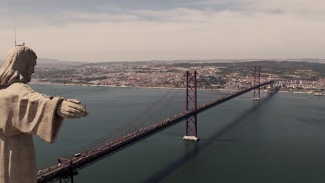 Open-arms-Cristo-Rey-overlooking-Lisbon-cityscape-and-25-de-Abril-Bridge-over-tagus-river
