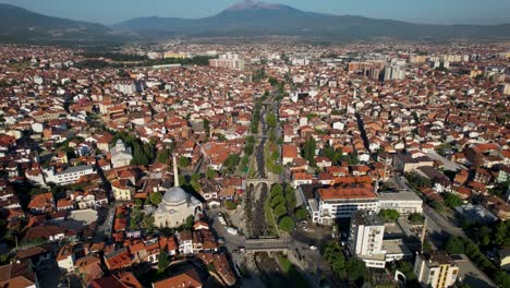 Beautiful-city-of-Prizren-with-river-in-the-middle,-traditional-neighborhoods-with-red-roof-houses
