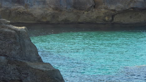 Clear-turquoise-seawater-in-a-cove-or-cala-creek-on-the-island-of-Minorca
