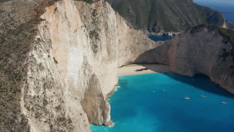 Turquoise-Water-Of-Shipwreck-Beach-Surrounded-with-Towering-Cliffs-In-Zakynthos-Island,-Greece