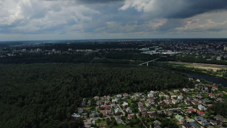 Kaunas-city-district-Panemune-with-beautiful-forest-on-stormy-day,-high-angle-drone-view