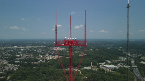 Two-tall-radio-towers-overlooking-city