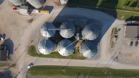 Ascending-drone-flight-over-a-farm-with-many-steel-silos-to-store-cereals-or-grain-for-domestic-cattle