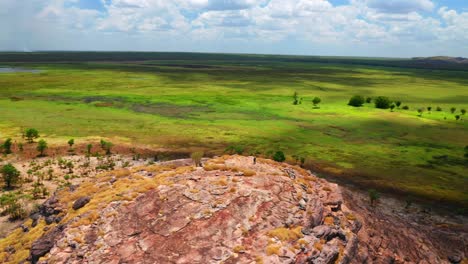 Person-On-Top-Of-Rocks-At-Ubirr-Surrounded-By-Wetlands-In-Kakadu-National-Park,-Northern-Territory,-Australia