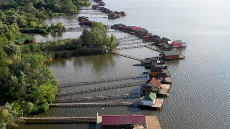 Tilting-upward-drone-shot-of-the-Bokod-Floating-Houses-in-Oroszlány,-Hungary