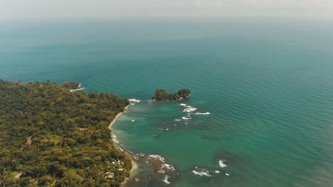Cinematic-flight-over-coastline-of-Punta-Mona-with-tropical-forest-and-beach-in-Costa-Rica---Beautiful-wide-view-of-Caribbean-Sea