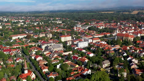 Wide-revealing-drone-shot-of-buildings-and-city-streets-of-Keszthely-in-Hungary