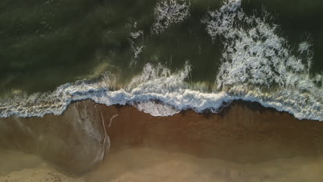 Ocean-waves-crashing-on-sandy-shore