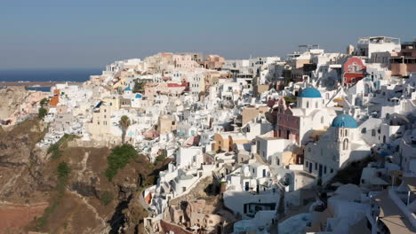 Houses-Of-The-Village-Of-Oia-On-the-Greek-Island-Of-Santorini---aerial-drone-shot
